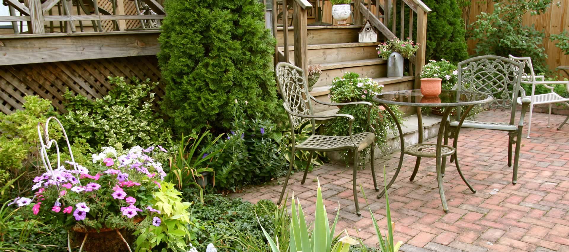 Outdoor patio and gardens with table and chairs