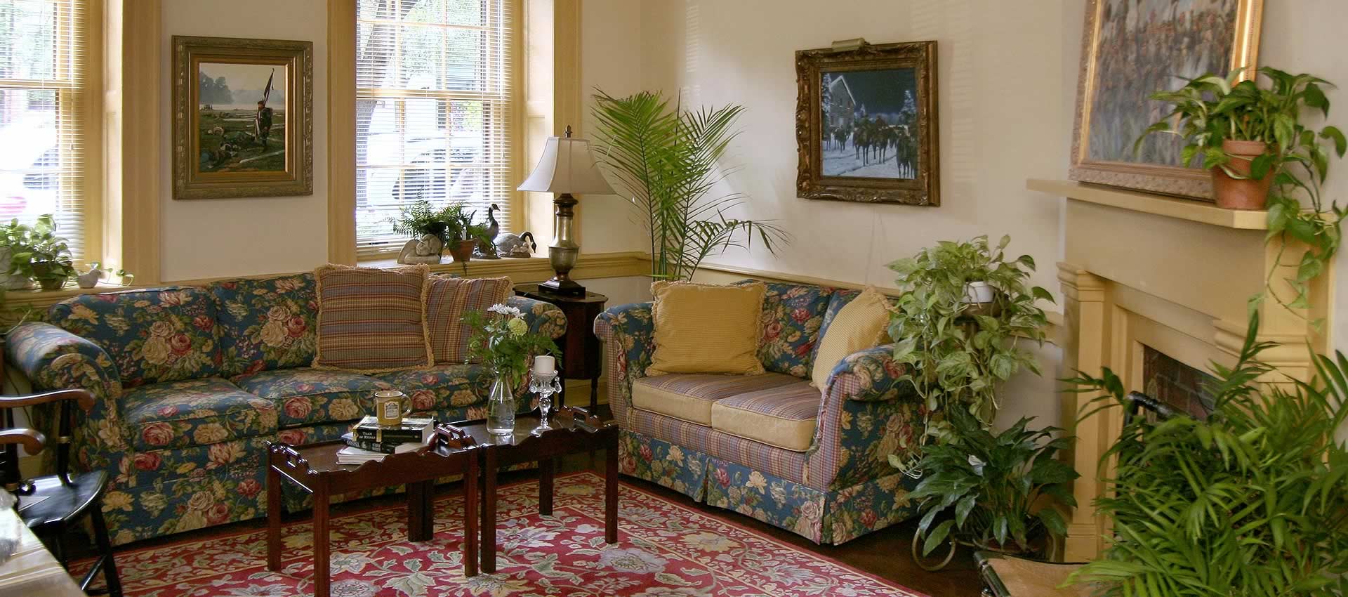 the common area living room with couch and loveseat and a fireplace