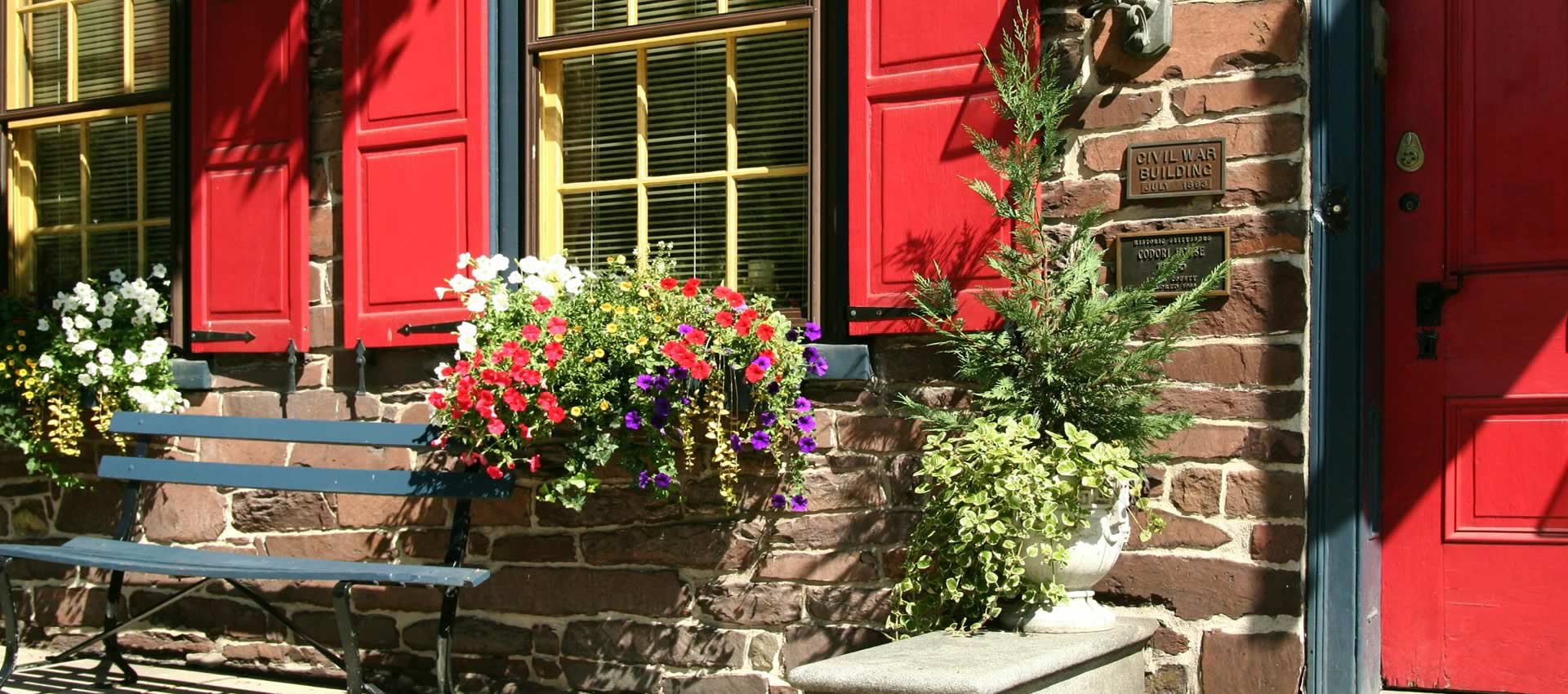 The front of Brafferton Inn with sitting bench and flower pots