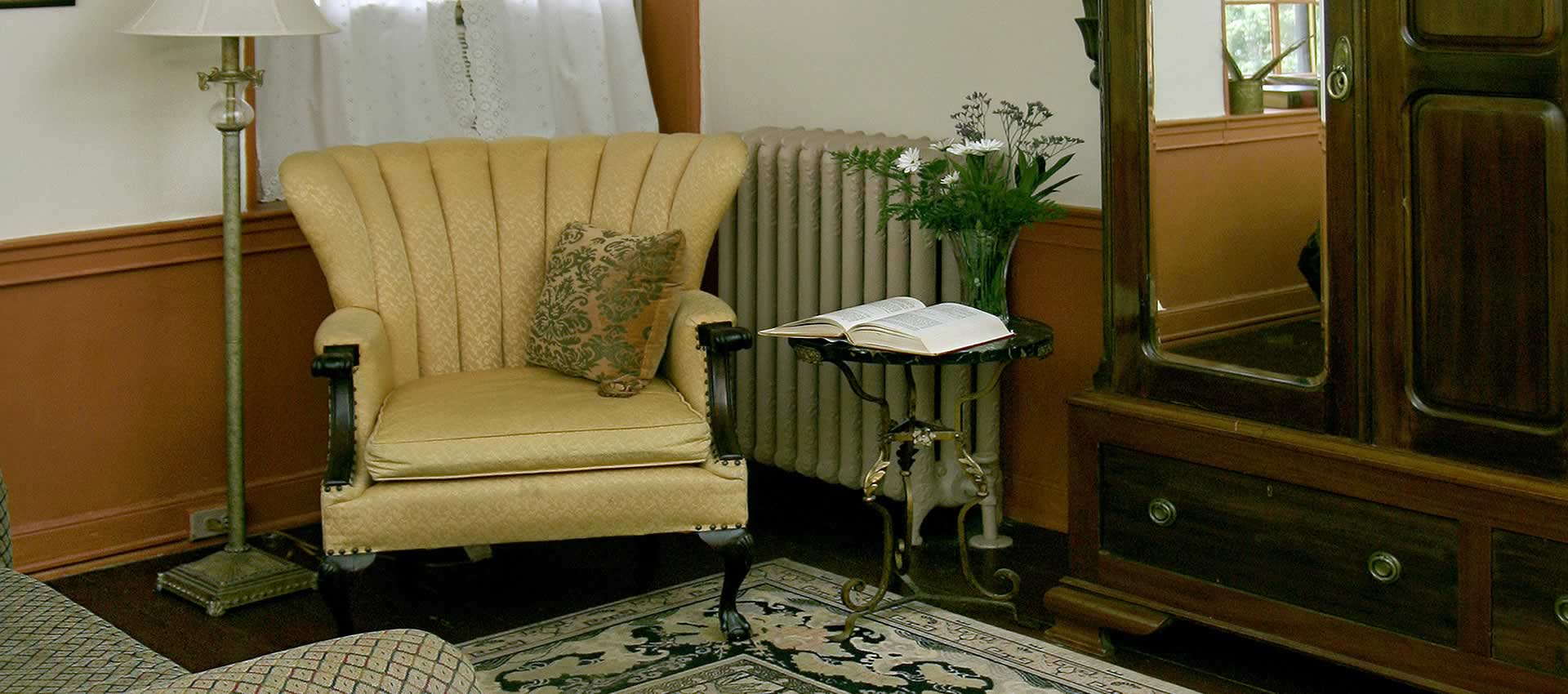 The Battle room sitting area with chair, lamps and table