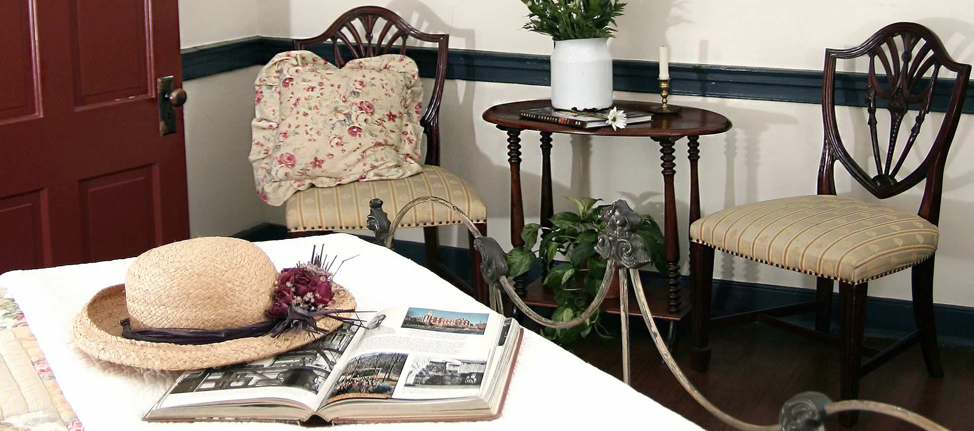 sitting area with hat and books on the table with chairs